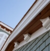 looking up at the roof of a house with a blue sky in the background