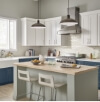 a kitchen with white Wolf cabinets, blue Wolf cabinets, a stove, a sink and a large island
