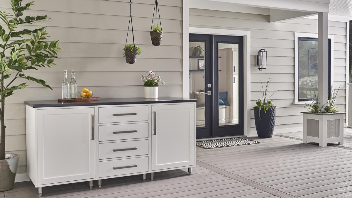 white Wolf outdoor cabinets with drawers sits outside of a house