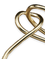 a close up of a gold object with a white background