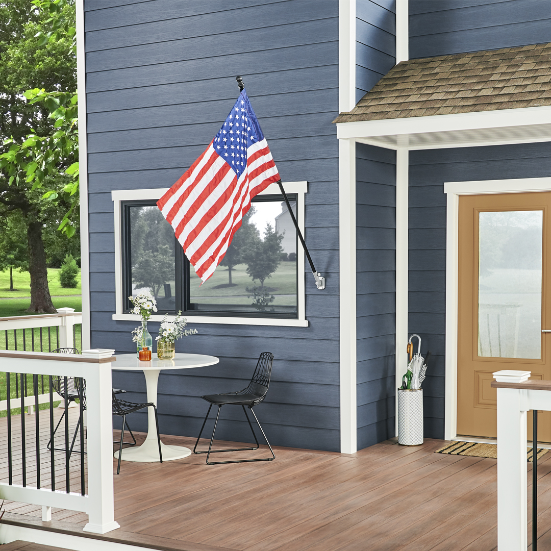 a blue house with an american flag on the porch