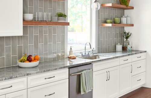 a kitchen with white Wolf cabinets and granite counter tops