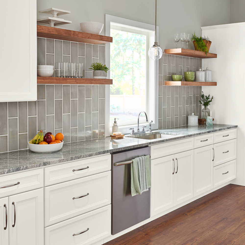 a kitchen with white Wolf cabinets and granite counter tops