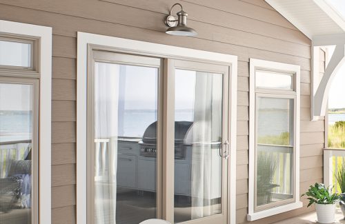 a patio with sliding glass doors using Wolf Portrait siding in Sandstone